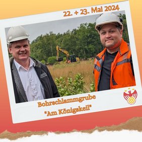 Zwei Personen lächeln in die Kamera. Im Hintergrund ist ein Bagger.